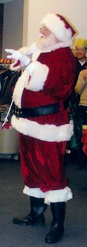 Santa Claus standing in christmas suit.