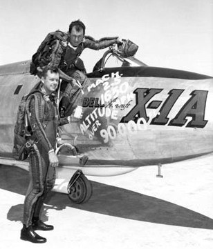 Vintage Chuck Yeager getting into airplane with co pilot.