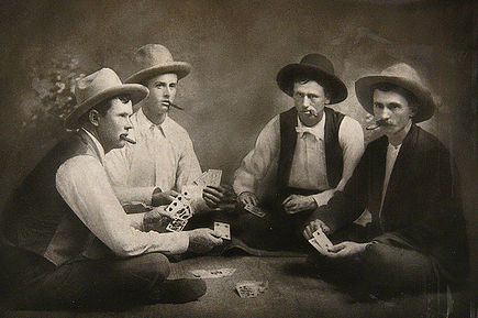 Vintage men playing cards while smoking.