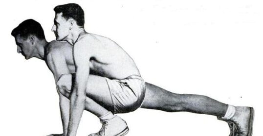 A man and a woman engaging in exercise by doing squats.
