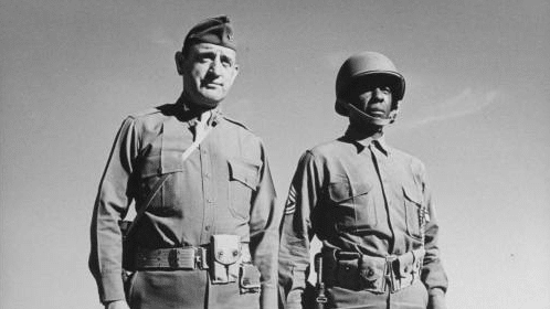 Two men in military uniforms from 2010 standing next to each other.