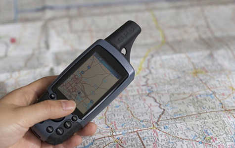 Man tracking location by using GPS device.