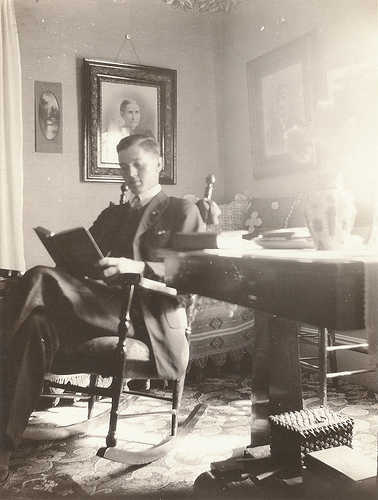 Vintage man reading book and sitting on the chair.