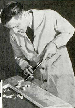 Vintage man using planer for smoothing the pieces of wood.