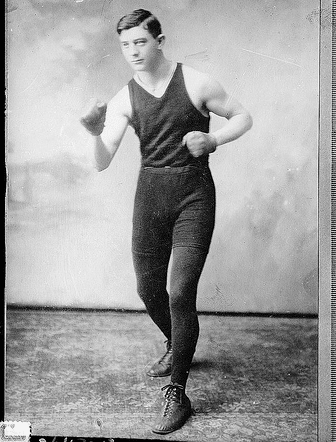 Description: A rediscovered photograph of a man in boxing gear, showcasing his passion for exercise.