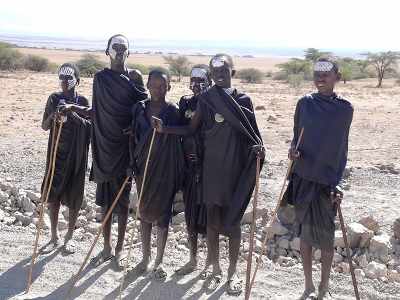 Maasai tribal boys standing in desert. 