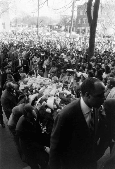 Vintage men carrying casket for funeral.