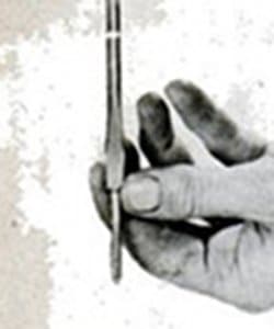 Vintage man holding a screwdriver in hand.