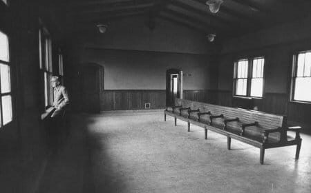 A vintage black and white photo of a nostalgic waiting room.