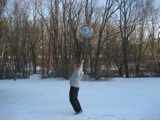 Man doing exercise of keg throwing in forest.