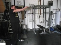 Man training with stones at gym.