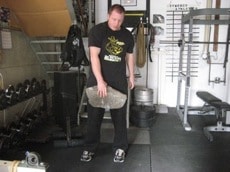 A man training with stones at gym.