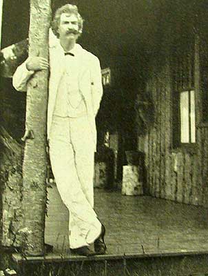 Mark Twain standing on deck.