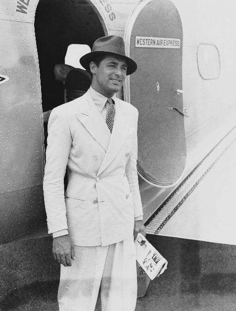 Man standing in front of aeroplane door.