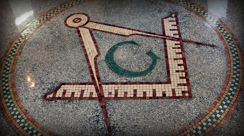An image of a masonic symbol on a tile floor showcasing the Freemasonry tradition.