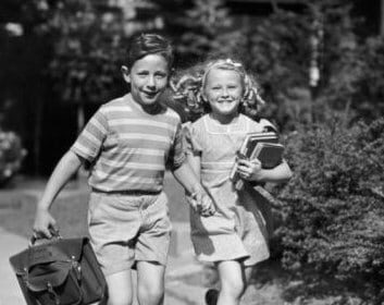 A black and white photo capturing the resiliency of two children as they engage in a playful game of running.