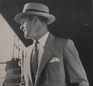 A man in a suit, representing Wardrobe, holding a briefcase while on the way to an important meeting.