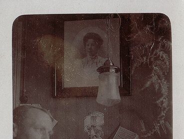 A man passionately engaged in his vocation at his desk, capturing an old photo.