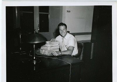 Finding a vocation - An old photo of a man sitting at a desk with papers.