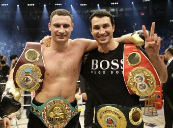 The Klitschko Brothers with heavyweight boxing belts.