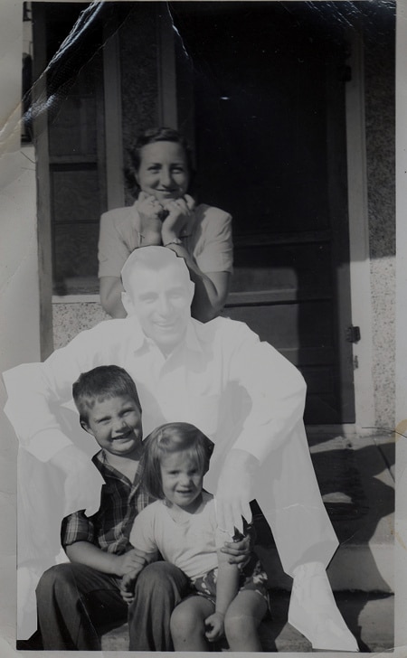 A black and white photo of a family posing for a picture, capturing the bittersweet moments after their recent loss.