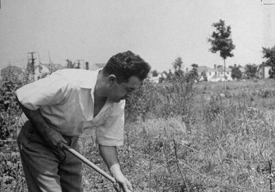 An old black and white photo capturing a man discovering his vocation in a field.