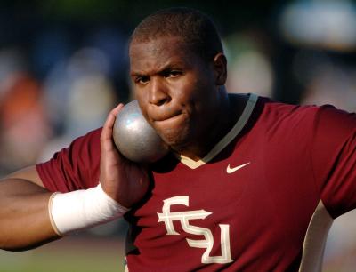 Garrett Johnson holding an iron ball.