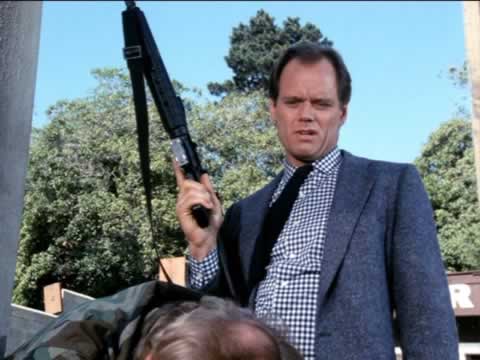 Fred Dryer carrying a gun in Rick hunter classic cop detective tv show.