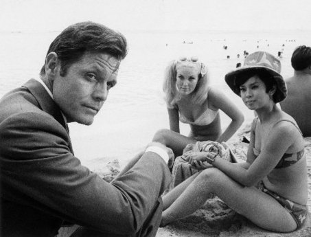 A man and girls on a beach from a hawaii five-o original classic cop detective tv show.