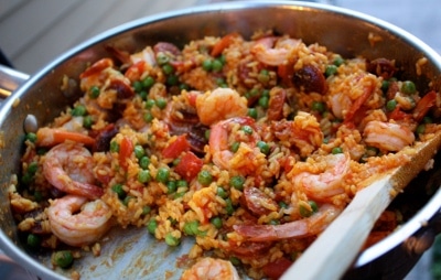 Shrimp chorizo paella one in pan with spoon.