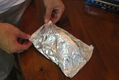 A man holding Aluminum foil packet.