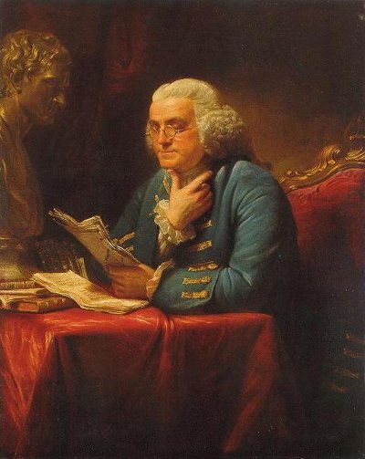 Benjamin Franklin sitting at table and reading papers portrait.