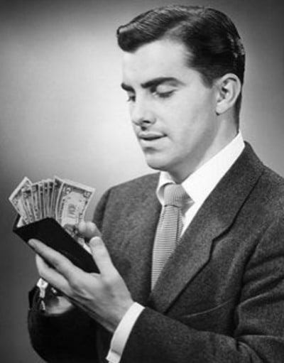 Vintage man holding wallet with money.