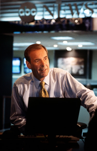 Peter Jennings abc news anchor sitting at computer desk.
