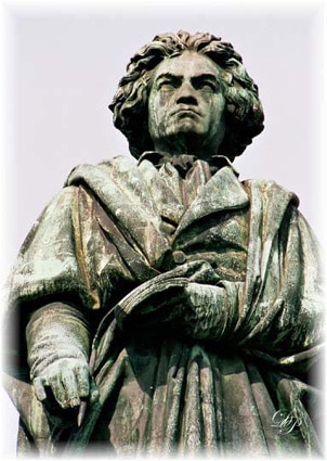 Beethoven statue of holding pocking notebook and pen.