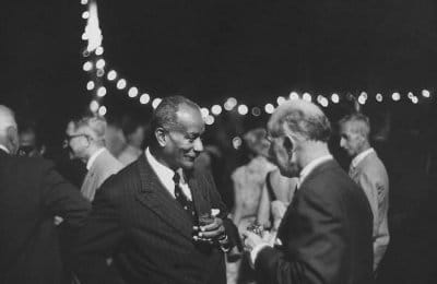 A black and white photo capturing the art of conversation at a party.