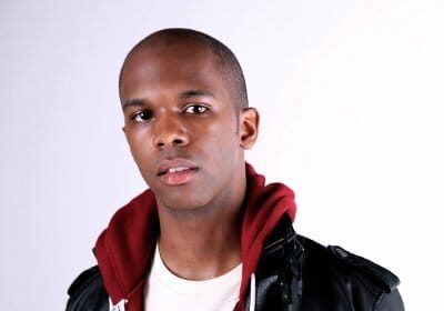 A young songwriter in a leather jacket and t-shirt.