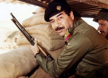 Saddam Hussein with gun.