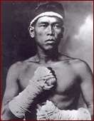 Ancient Muay Thai fighter portrait with taped hands.