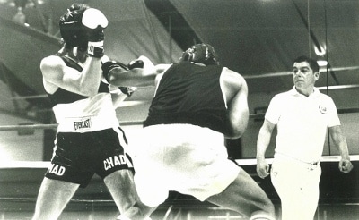 A black and white photo of two amateur boxers in a boxing ring.