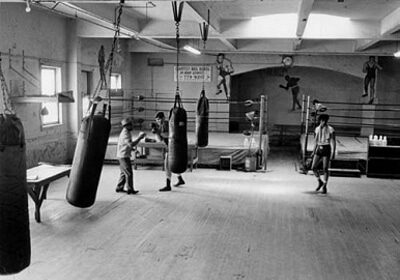 A black and white photo capturing the essence of an Amateur Boxing gym, perfect for Beginners seeking a How-to Guide.