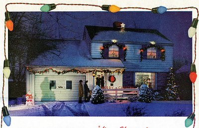 House decorated with Christmas lights in snow.