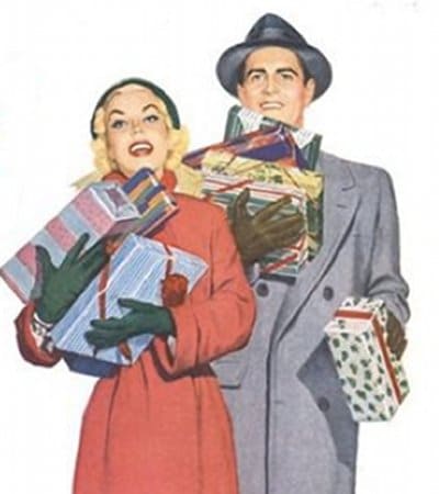 Couple smiling while holding Christmas presents. 