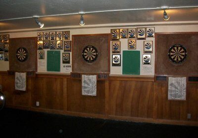 A game with several darts on a dart board.