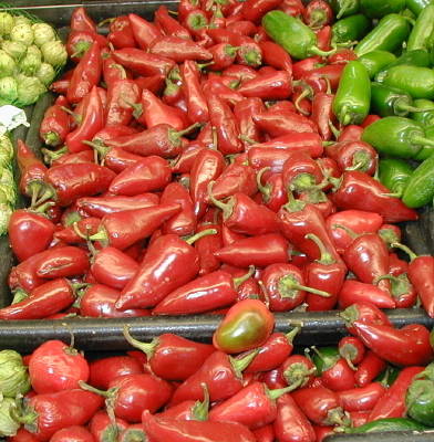 Fresno red and green peppers in store shelves.