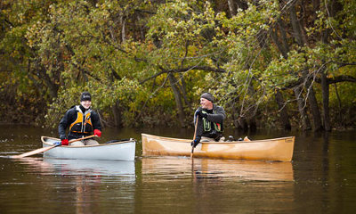 Two men canoeing on lake.