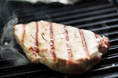 Timorese Tuna steak cooking on grill.