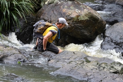 Man wading in river for adventure.