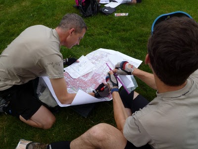 Men looking at map navigating for racing.