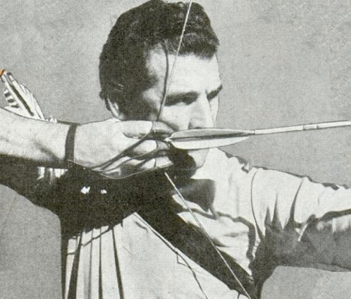 Vintage man pulling back bow and arrow.